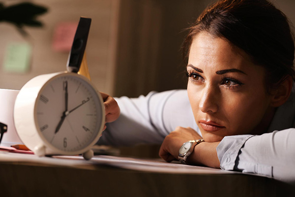 Business woman by analogue clock